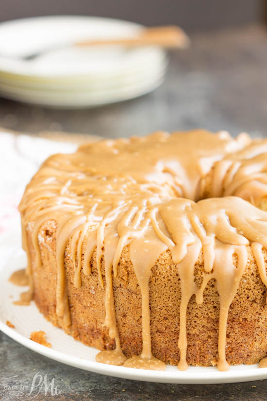 Cold Oven Brown Sugar Whipping Cream Pound Cake is perfectly moist and velvety on the inside with that crusty top that's loved so much. #cake #poundcake #poundcakefromscratch #poundcakepaula #dessert #recipe #fromscratch #callmepmc #recipes #baked Whole whipping cream pound cake with caramel icing on a table.