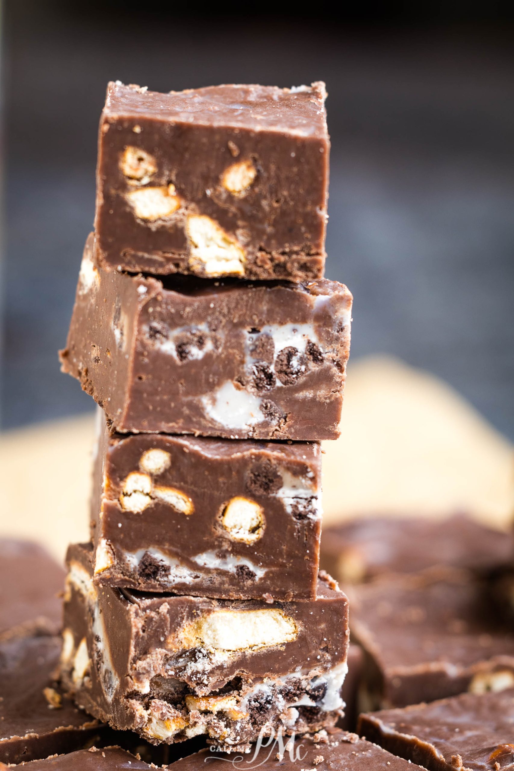 KISSES® Cookies & Cream Chocolate Fudge - need a holiday gift are treat? This fudge recipe filled with Hershey kisses is perfectly rich and decadent, but best of all it's easy! A stack of chocolate fudge stacked on top of each other.